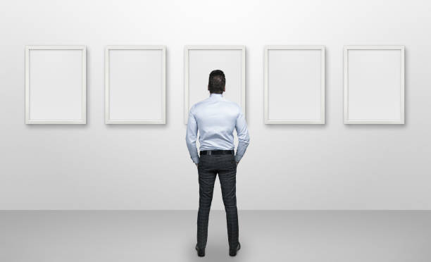 istock Young business person looking blank picture frames 846329714