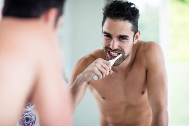 istock Portrait of a handsome man brushing teeth 846330162