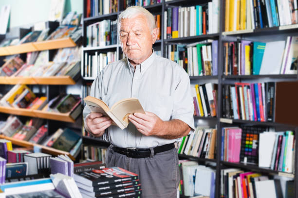 istock Senior male is looking new book for reading 846330244