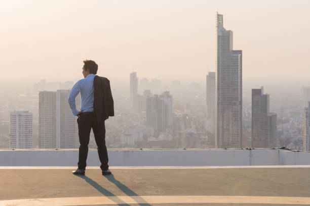 istock Businessman is looking at city on rooftop 846331016