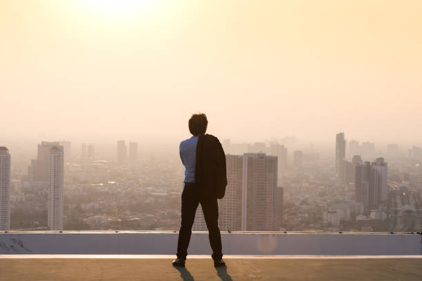 istock Businessman is looking at city on rooftop 846331142