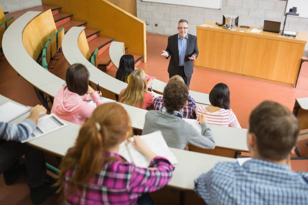 istock Elegant teacher with students at the lecture hall 846333708