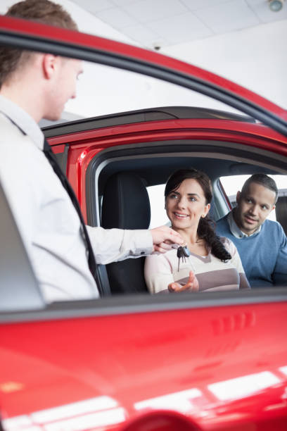 istock Smiling customer receiving car keys 846333730