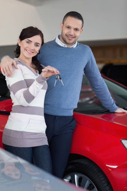 istock Happy couple embracing while holding keys 846334062