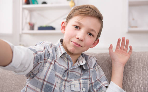 istock Male child taking selfie on phone at home 846334304