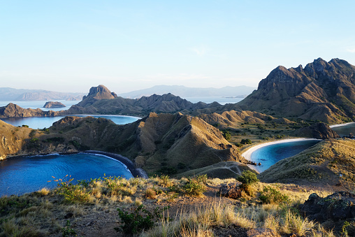 Padar Island with scenic high view of three beautiful white sandy beaches surrounded by a wide ocean and part of komodo national park in Flores, Indonesia.