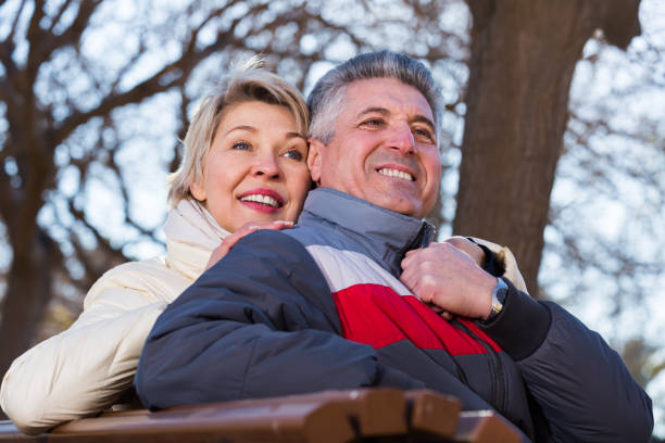 istock Smiling mature couple relaxing in park 846338106