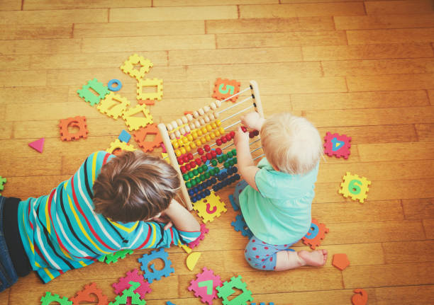 istock kids playing with number puzzle and abacus 846339562