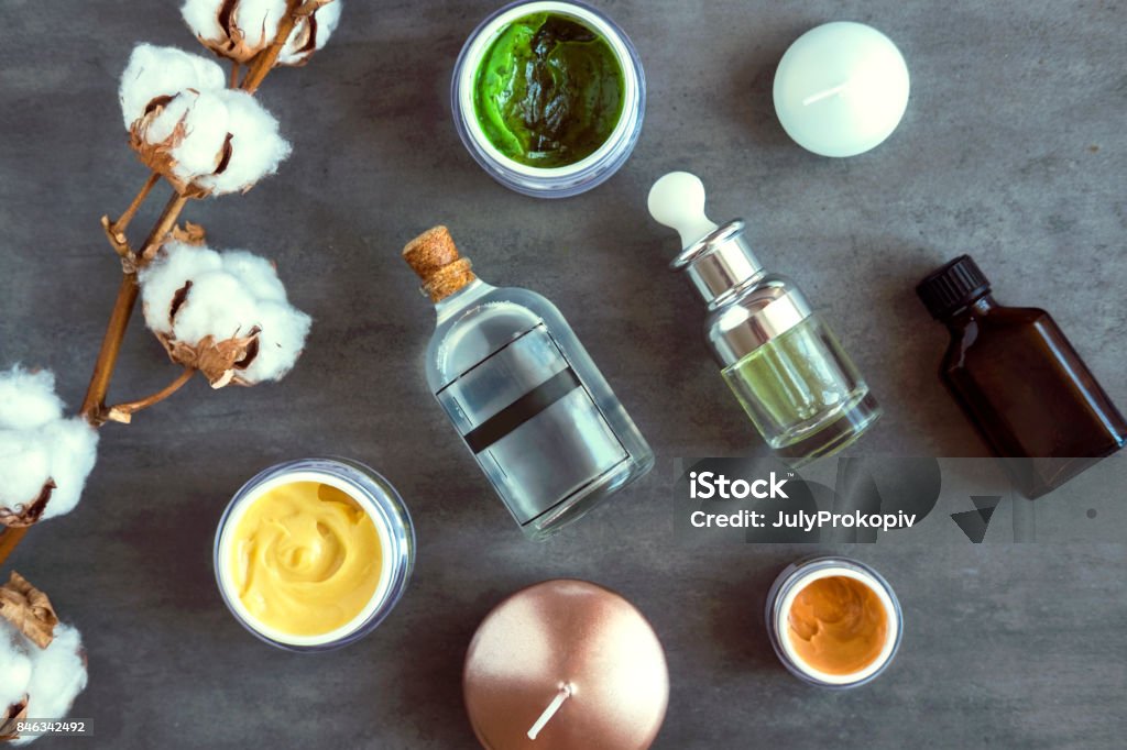 SPA beauty creams and oils on dark table SPA cosmetic products on dark table from above. Coconut, argan oils, organic creams and serums. Beauty blog flatlay Anti Aging Stock Photo