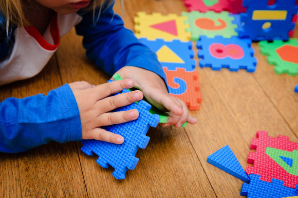 istock little girl playing with puzzle, early education 846342576