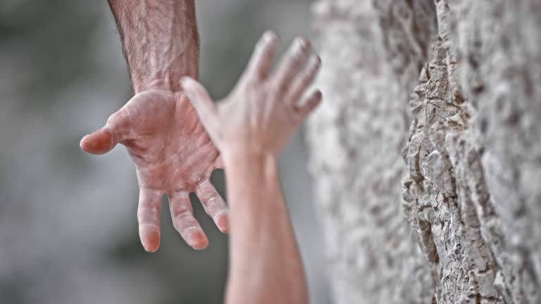 SLO MO LD Male and female climber's hand holding each other