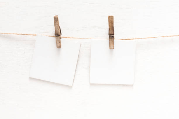 istock White blank cards on rope, light wall background 846346842