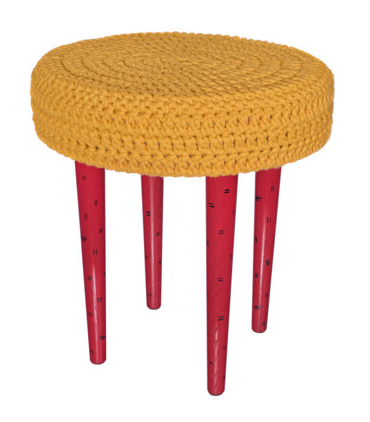istock Handmade stool red in black patterns. Round seat in yellow woolen material. 846351264