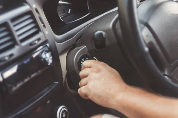 istock man's hand starts a car with the key in retro toning 846358600