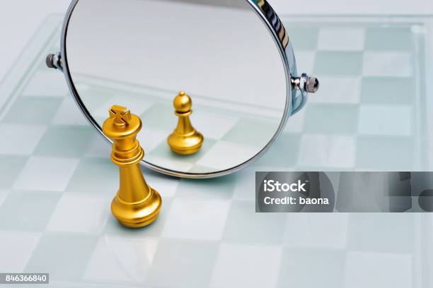 Golden Chess King Imagining Itself As A Pawn Stock Photo - Download Image Now - Mirror - Object, Change, Pawn - Chess Piece