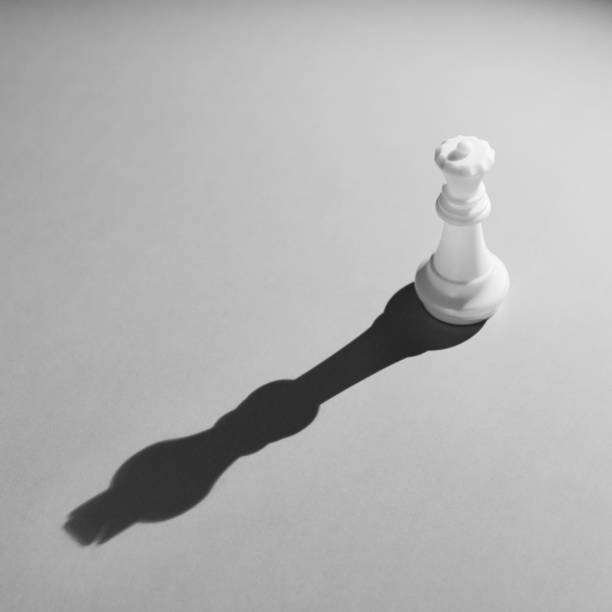 istock White chess queen with the shadow of a king 846369610