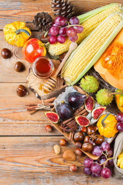 istock Fall autumn harvest background with pumpkin apple chestnut corn 846373300