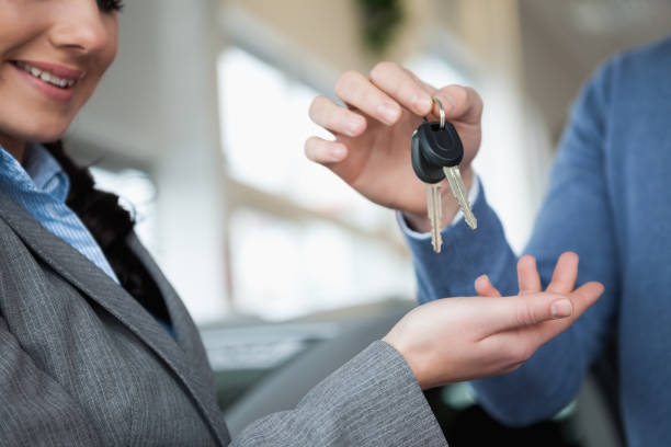 istock Smiling woman receiving keys from a hand 846374534