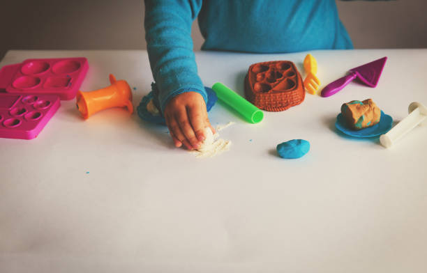 istock Child playing with clay molding shapes 846374644