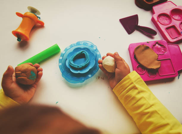 istock Child playing with clay molding shapes 846374708