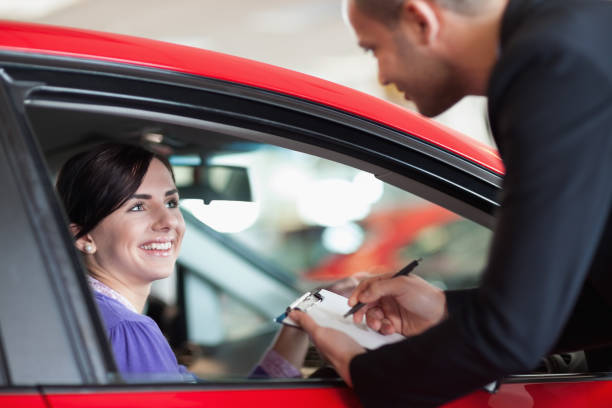 istock Woman in a car talking with a salesman 846377524
