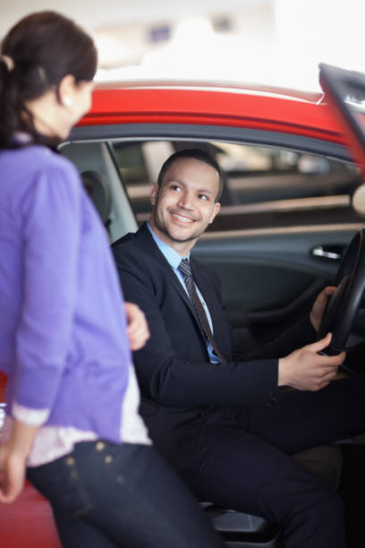 istock Man sitting in a car while talking to a woman 846377748