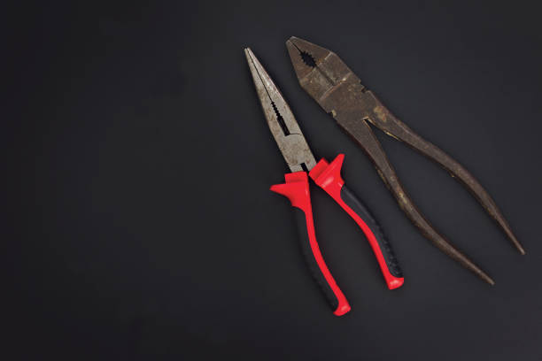 istock Must have at home used hand tools Combination Pliers and Needle Nose Pliers on black background with copy space 846378394