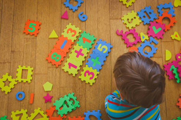 istock little boy playing with puzzle, education concept 846380584