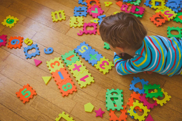 istock little boy playing with puzzle, education concept 846380948