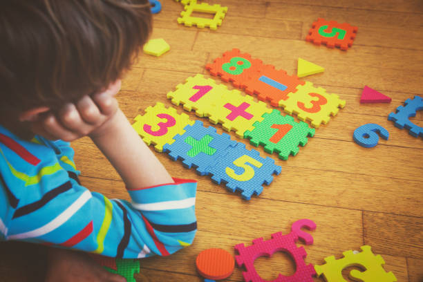 istock little boy playing with puzzle, education concept 846381402