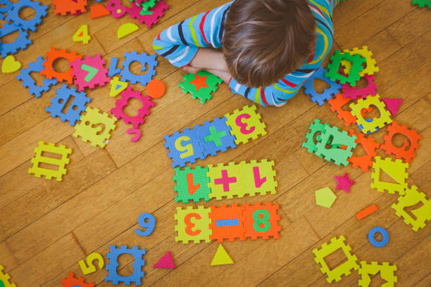 istock little boy playing with puzzle, education concept 846381508