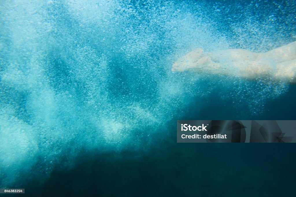 Swimmer legs and bubbles Swimmer legs and bubbles underwater, summer vacation diving Leg Stock Photo
