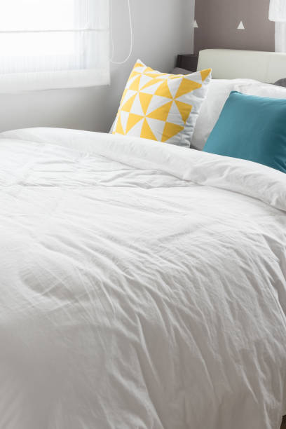 istock colorful pillows on white bed in modern bedroom 846383258