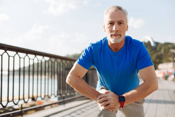istock Handsome senior man doing lunges on the bridge 846385646