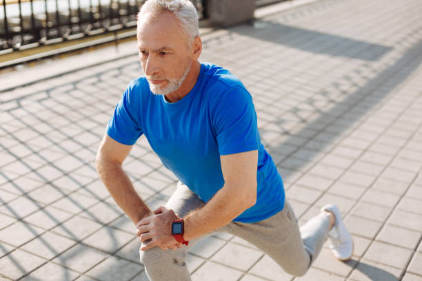 istock Pleasant senior man performing lunges in the street 846385848