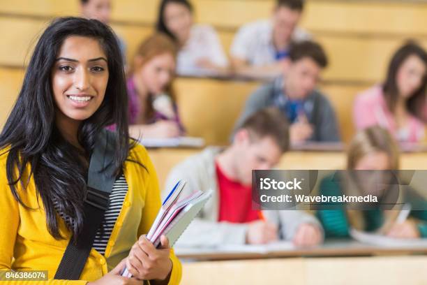 Smiling Female With Students Sitting At The Lecture Hall Stock Photo - Download Image Now