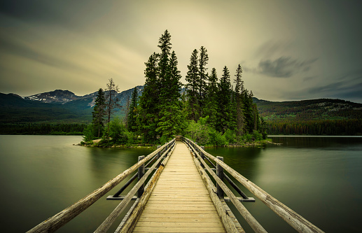 Cold summer evening at the Pyramid Lake and the little Pyramid Island in Jasper National Park, Alberta, Canada. Long exposure.