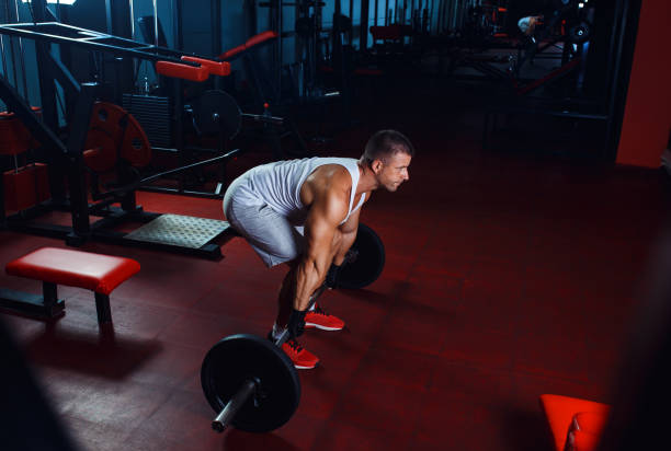 istock Young man exercising with weight in the gym. 846388850