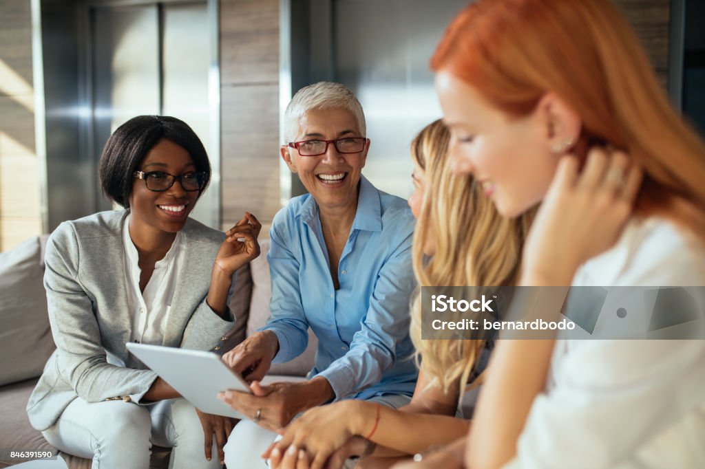 Working as a team Happy business woman working together online on a tablet. Businesswoman Stock Photo