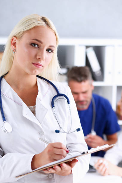 istock Beautiful smiling female doctor hold clipboard pad 846391764