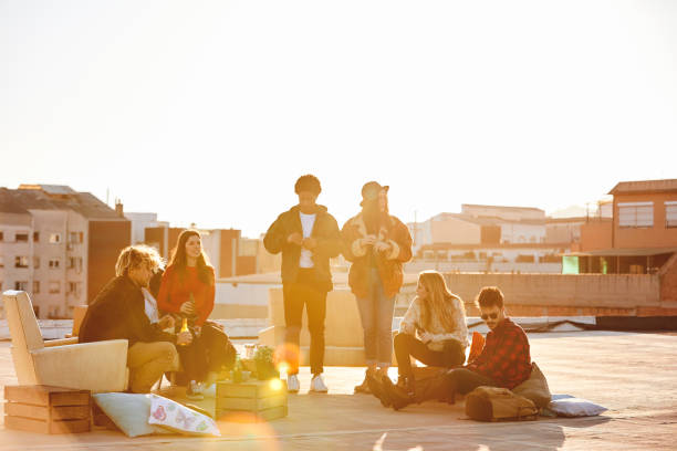istock Friends partying on building terrace during summer 846394250