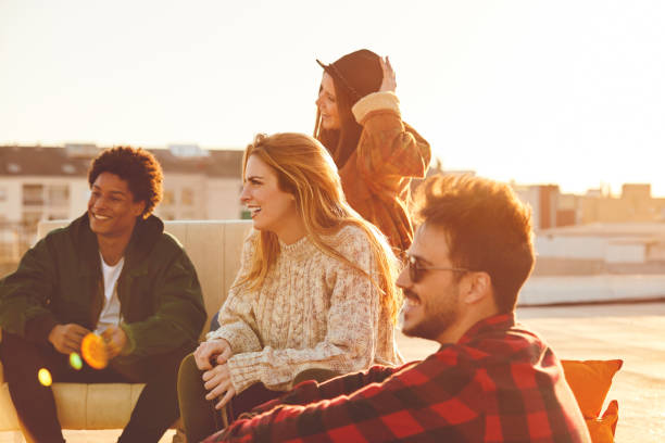 istock Happy friends resting on sofa at rooftop 846394372
