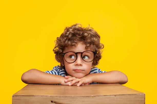 pensive charming boy on studio background - charming imagens e fotografias de stock