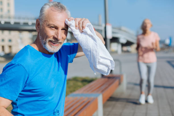 istock Senior man wiping sweat from the forehead with towel 846400038