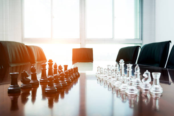 istock Chess pieces and board on the conference table 846402574