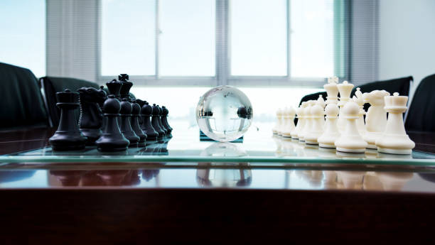 istock Chess pieces and glass earth globe on the conference table 846406270