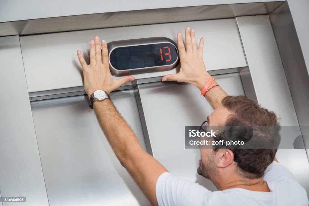 Phobia thirteen Man is afraid of number thirteen on elevator display. Number 13 Stock Photo