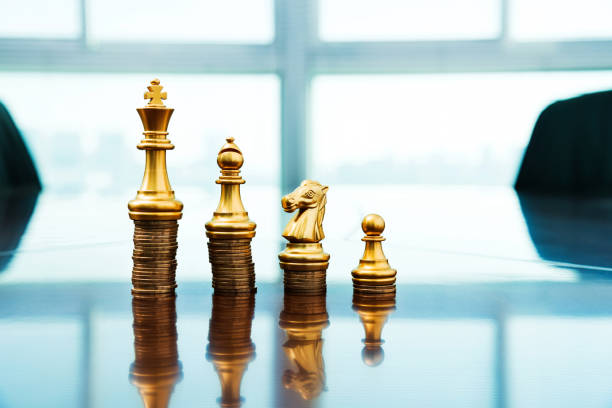 istock Chess pieces standing on the stacked coins 846406576