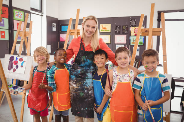 istock Teacher and schoolkid standing together in drawing class 846409768