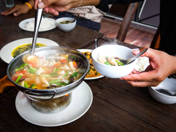 istock Northern Style Spicy Chicken Soup (Tom Yum Gai) in hot pot on food table 846410708